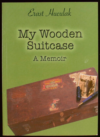 Green book cover showing a well worn wooden suitcase with a photograph on top.